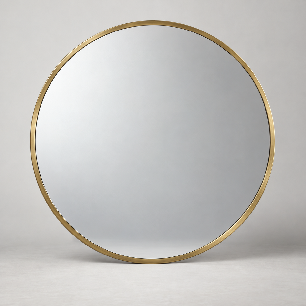 Aro Round Mirror on a pale studio background