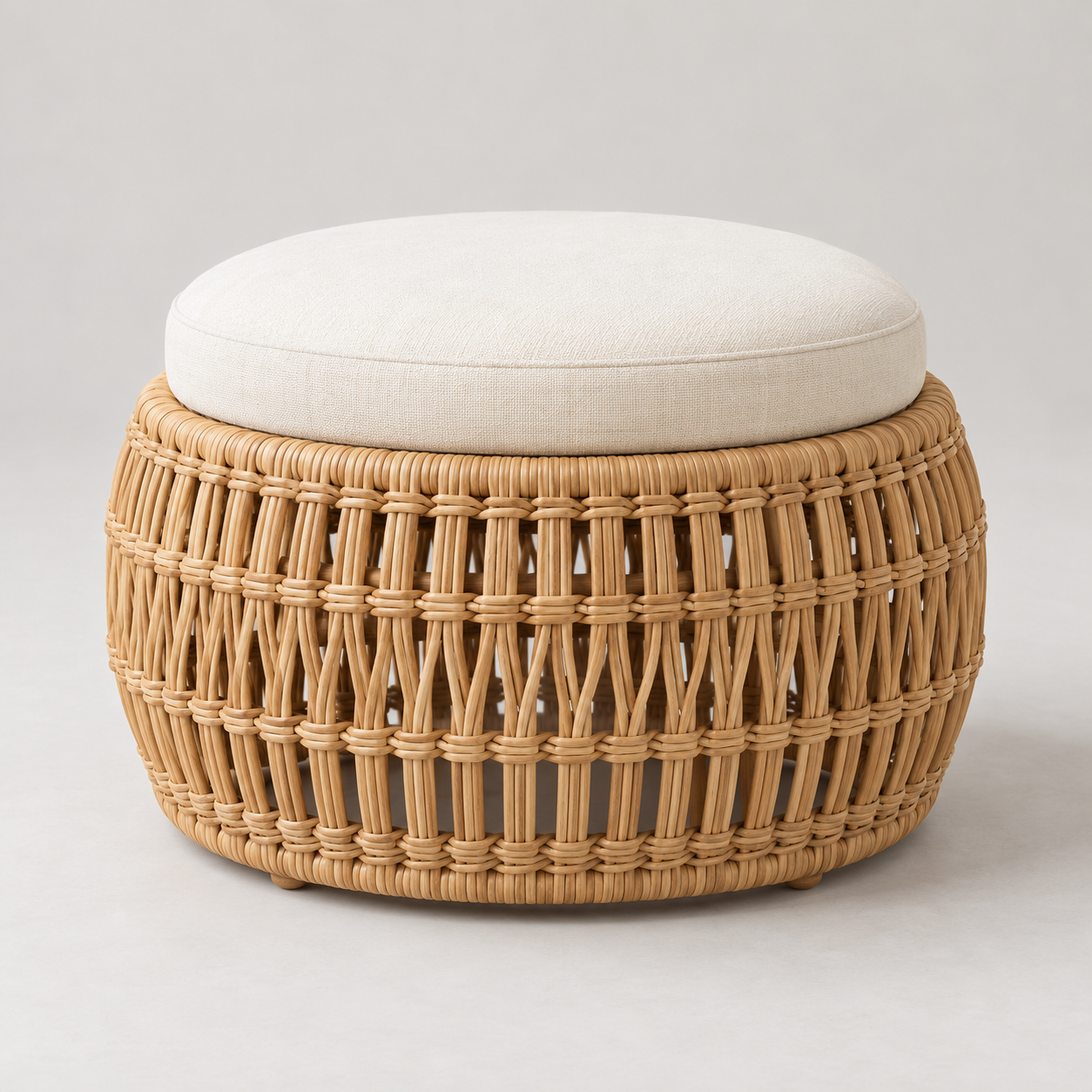 Cesta Woven Ottoman on a pale studio background