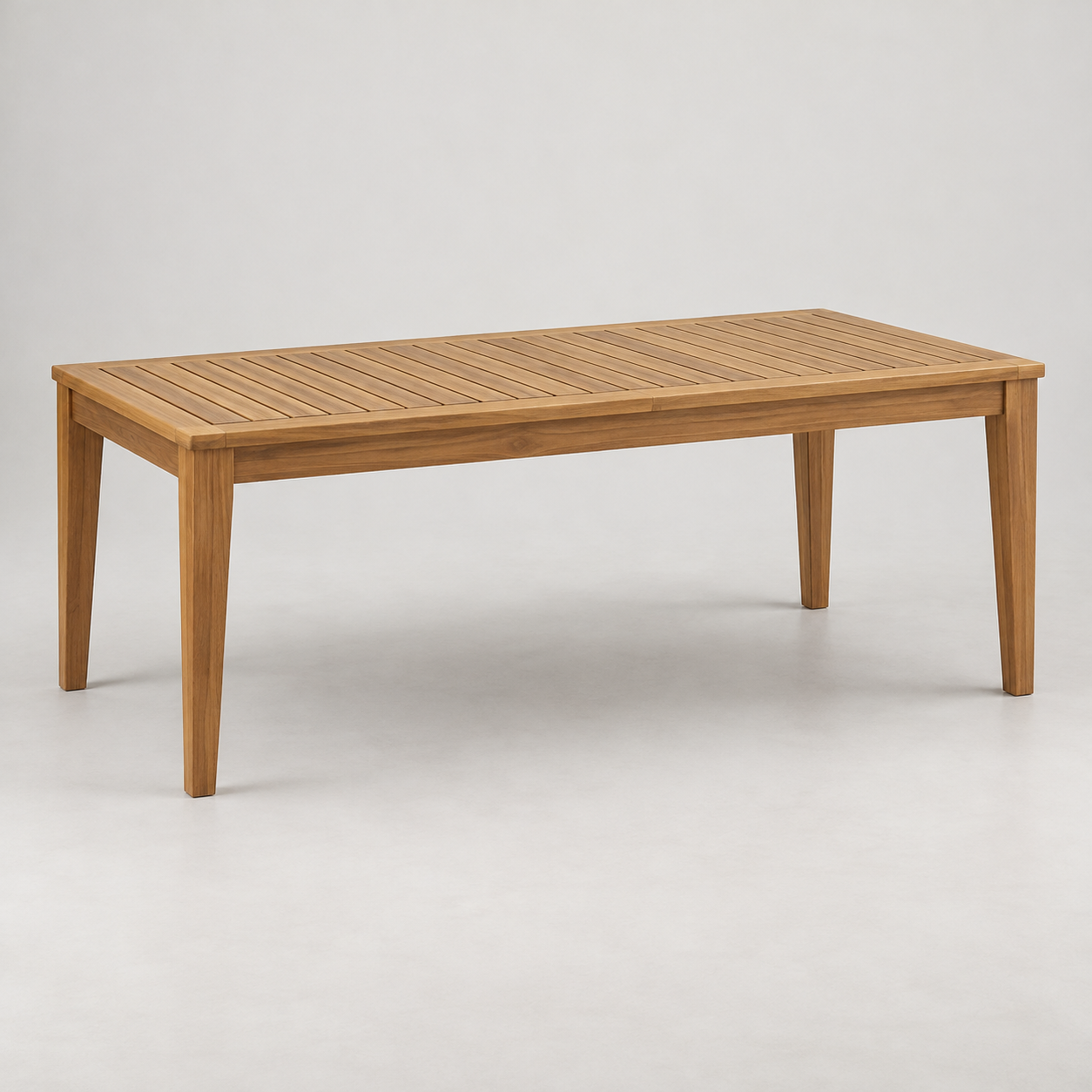 Mar Teak Dining Table on a pale studio background