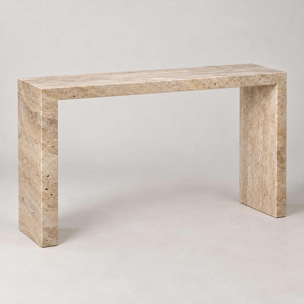 Rill Travertine Console on a pale studio background